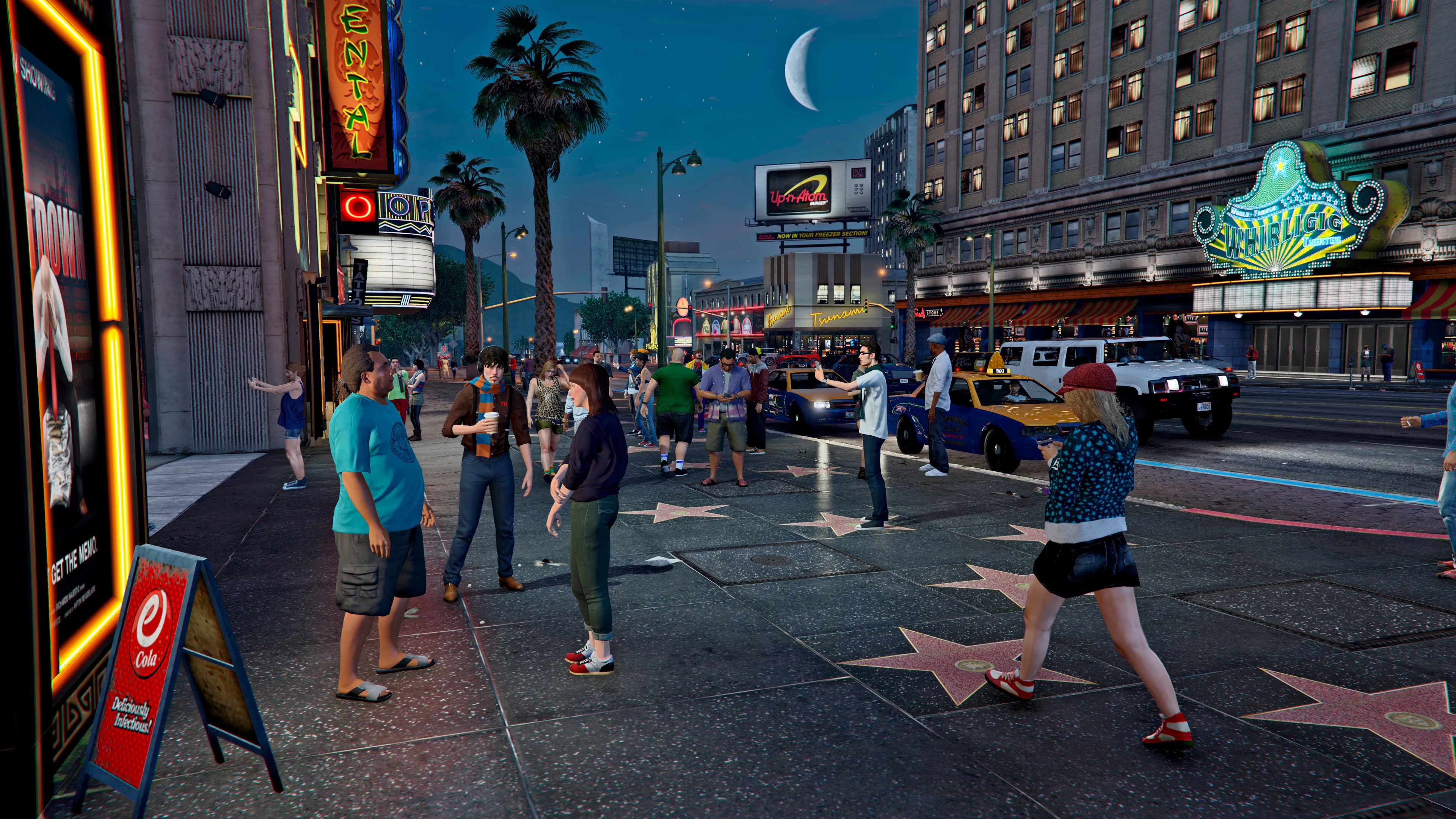 Theaters, marquees, traffic, and crowds filling Vinewood after dark