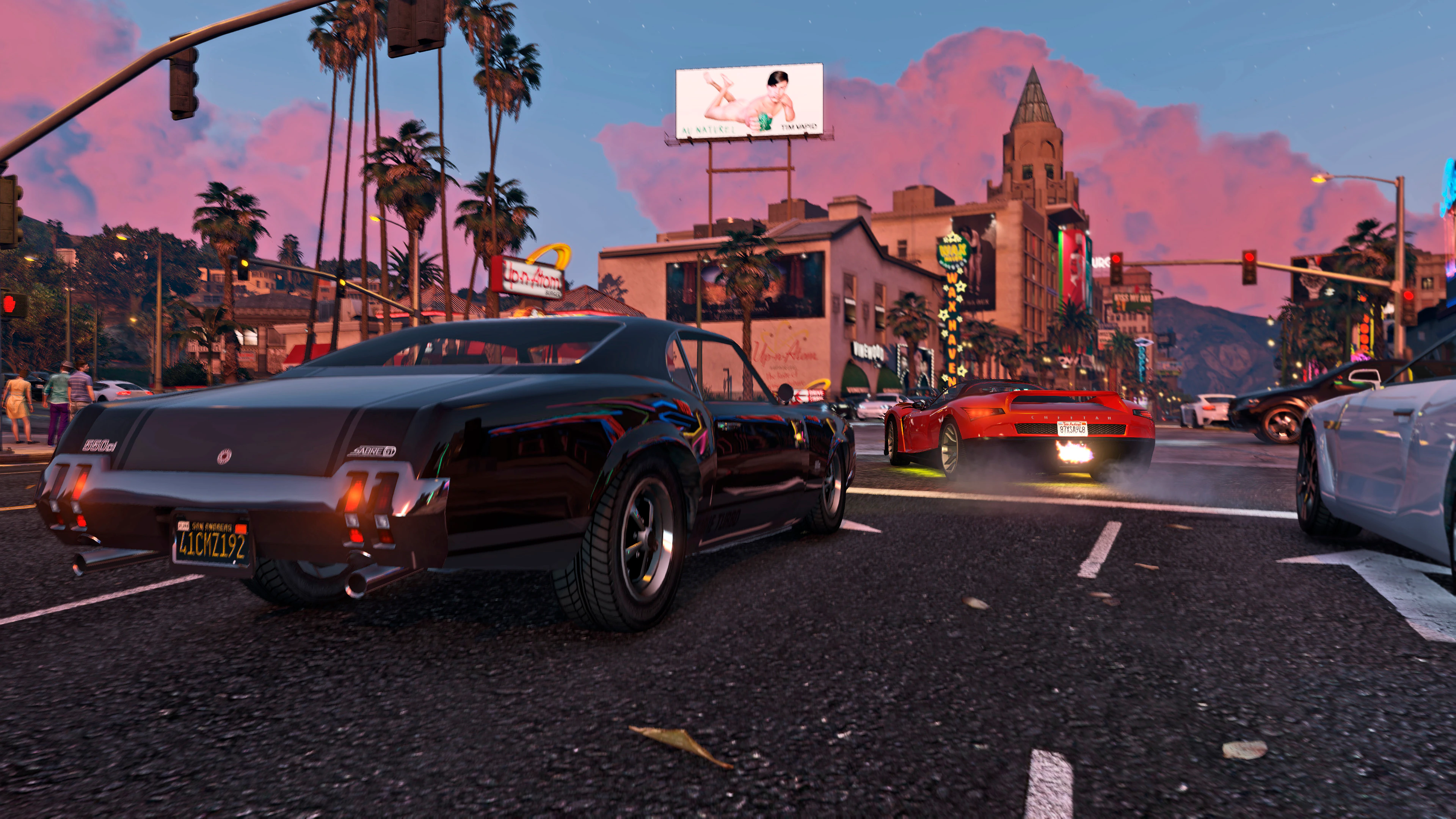 Performance cars accelerating through a closed Los Santos boulevard at sunset